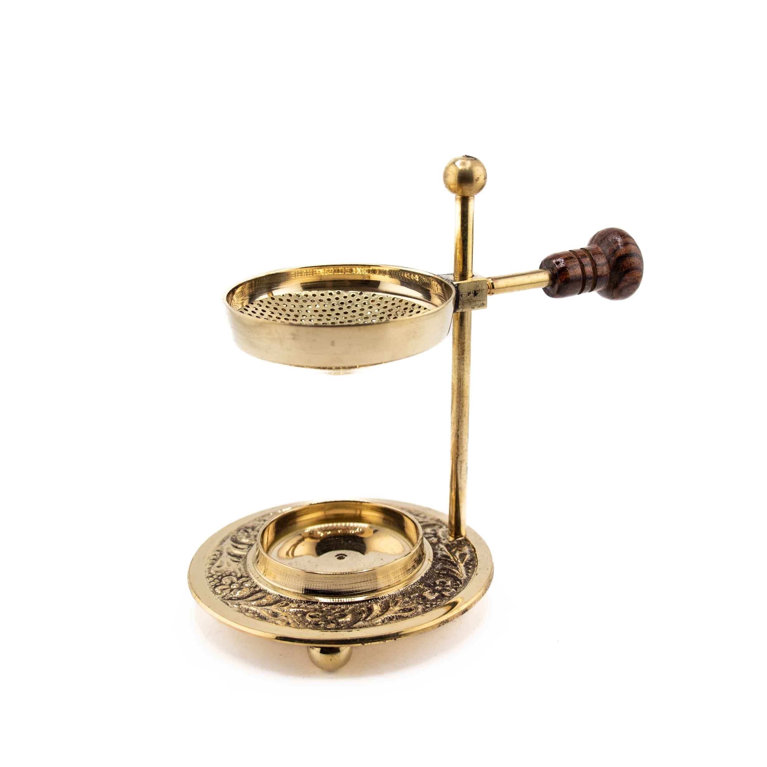 An adjustable brass resin burner featuring a perforated screen tray, a wooden adjustment knob, and a decorative floral-etched base.