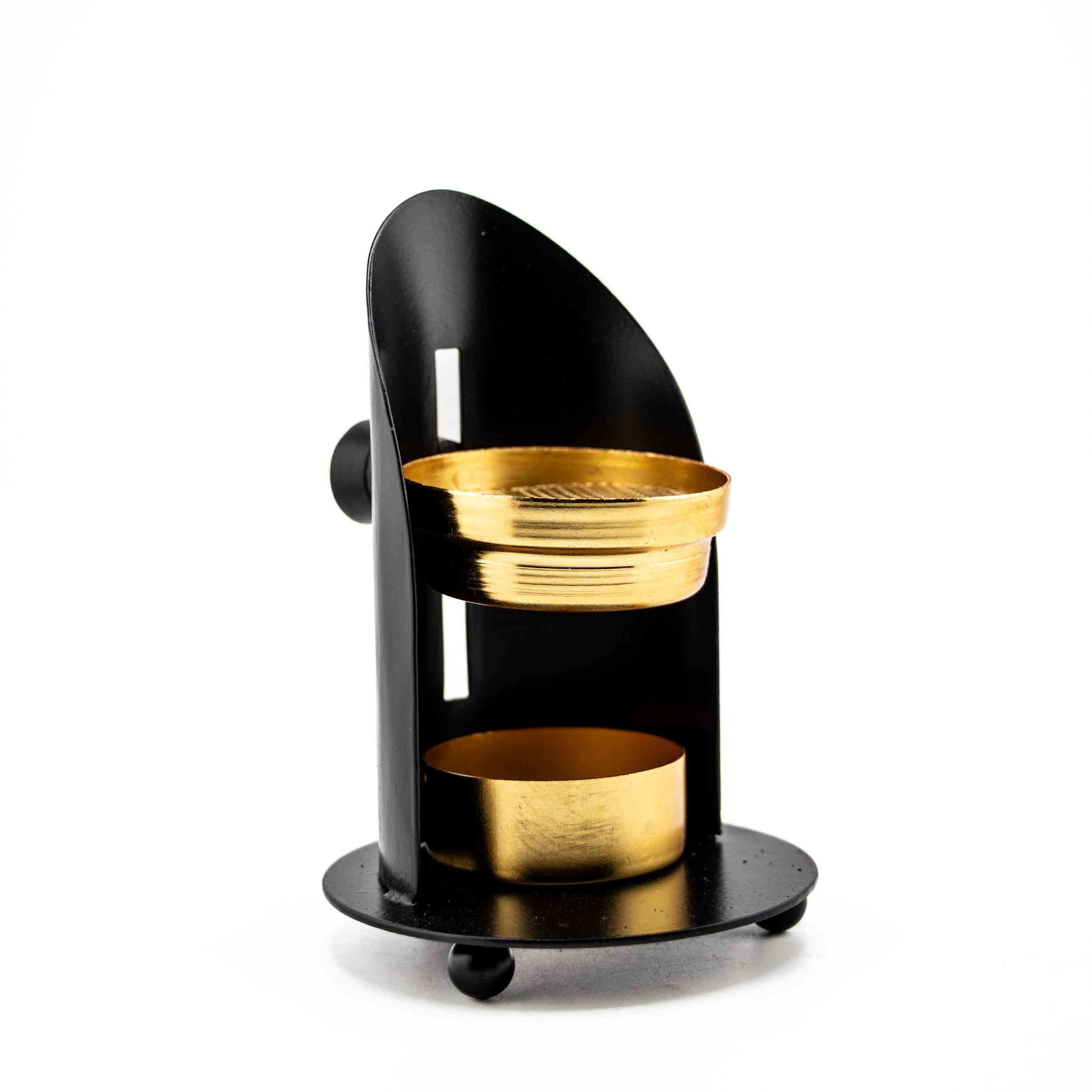 An adjustable black metal resin burner featuring a gold-toned mesh tray and candle holder, set against a curved matte black backdrop.