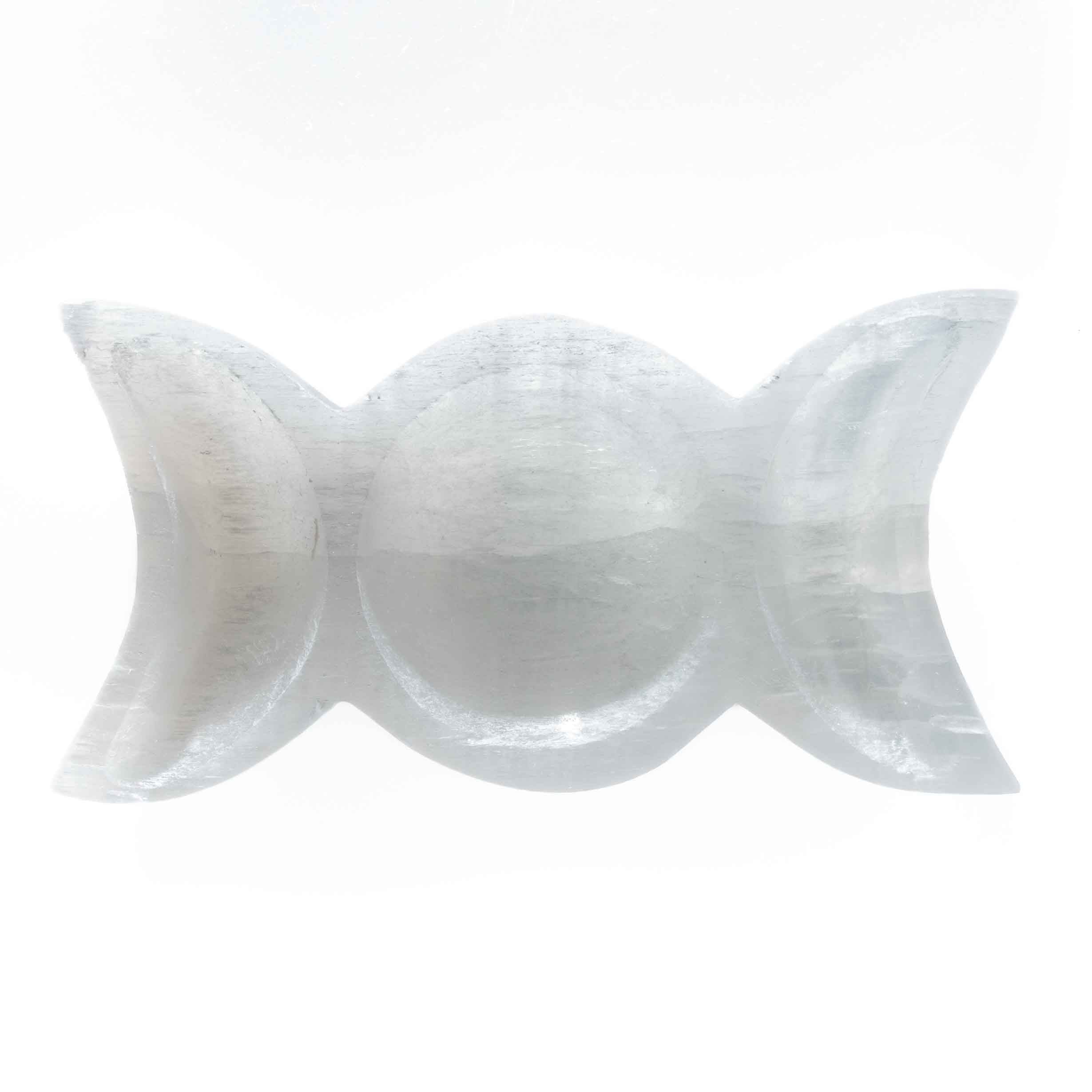 7-inch white selenite triple moon goddess bowl with full and crescent moon carved design, natural fibrous texture on white background.