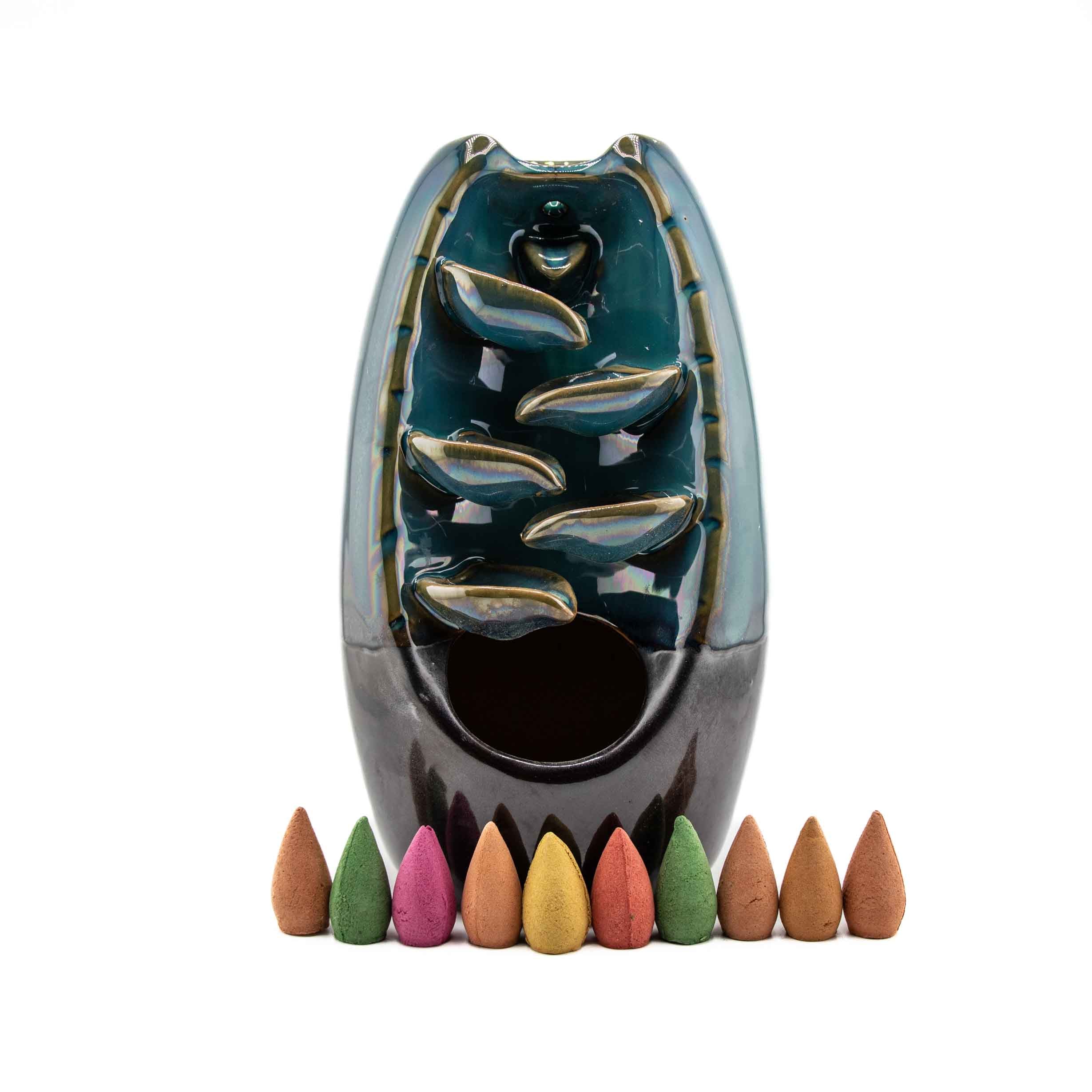 Teal ceramic waterfall backflow incense cone burner, 7.5", with tiered cascade design, displayed with assorted colored incense cones on white background.