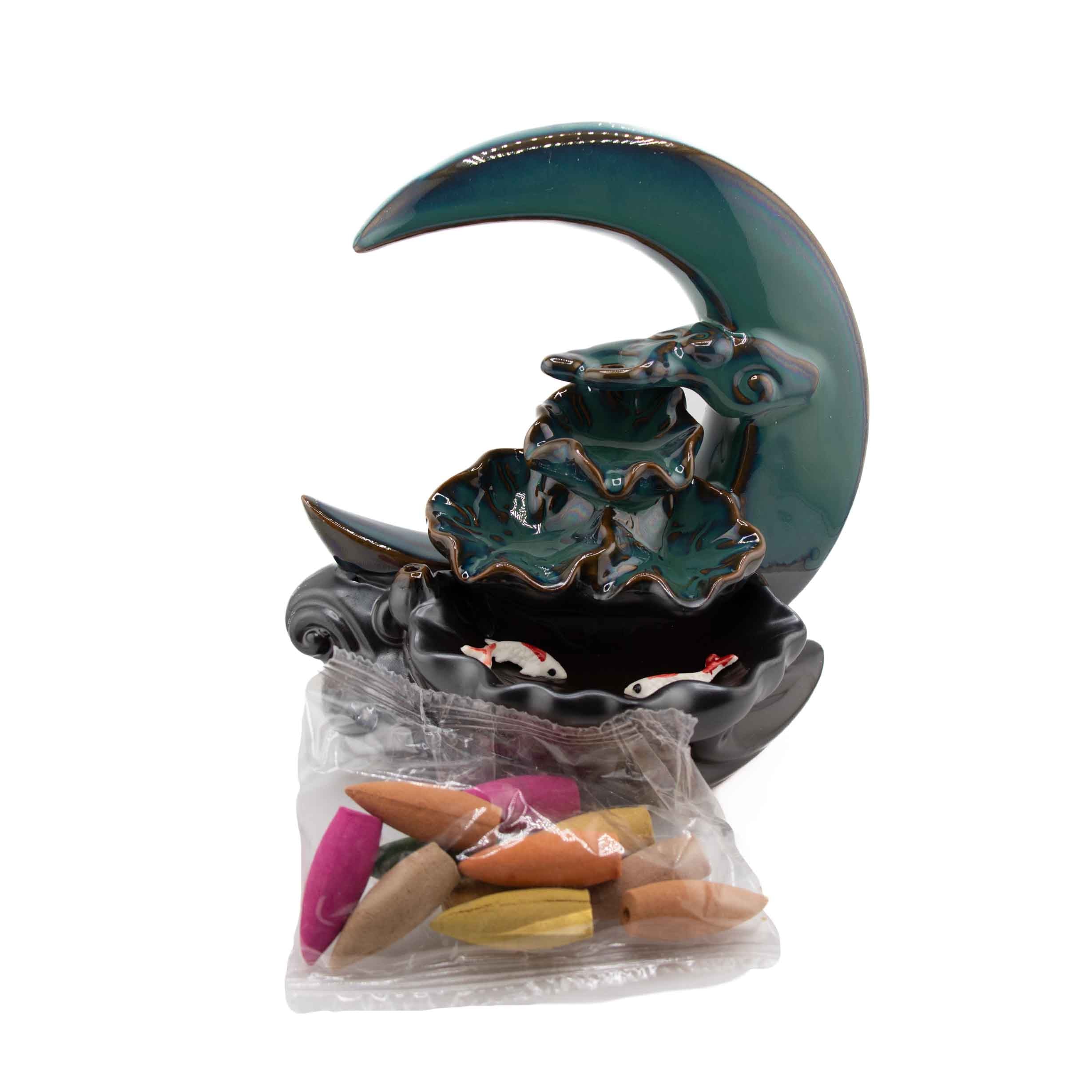 Teal ceramic crescent moon backflow incense cone burner, 7"H x 4.5"W, with tiered cascade, koi fish pond base, and included assorted incense cones on white background.