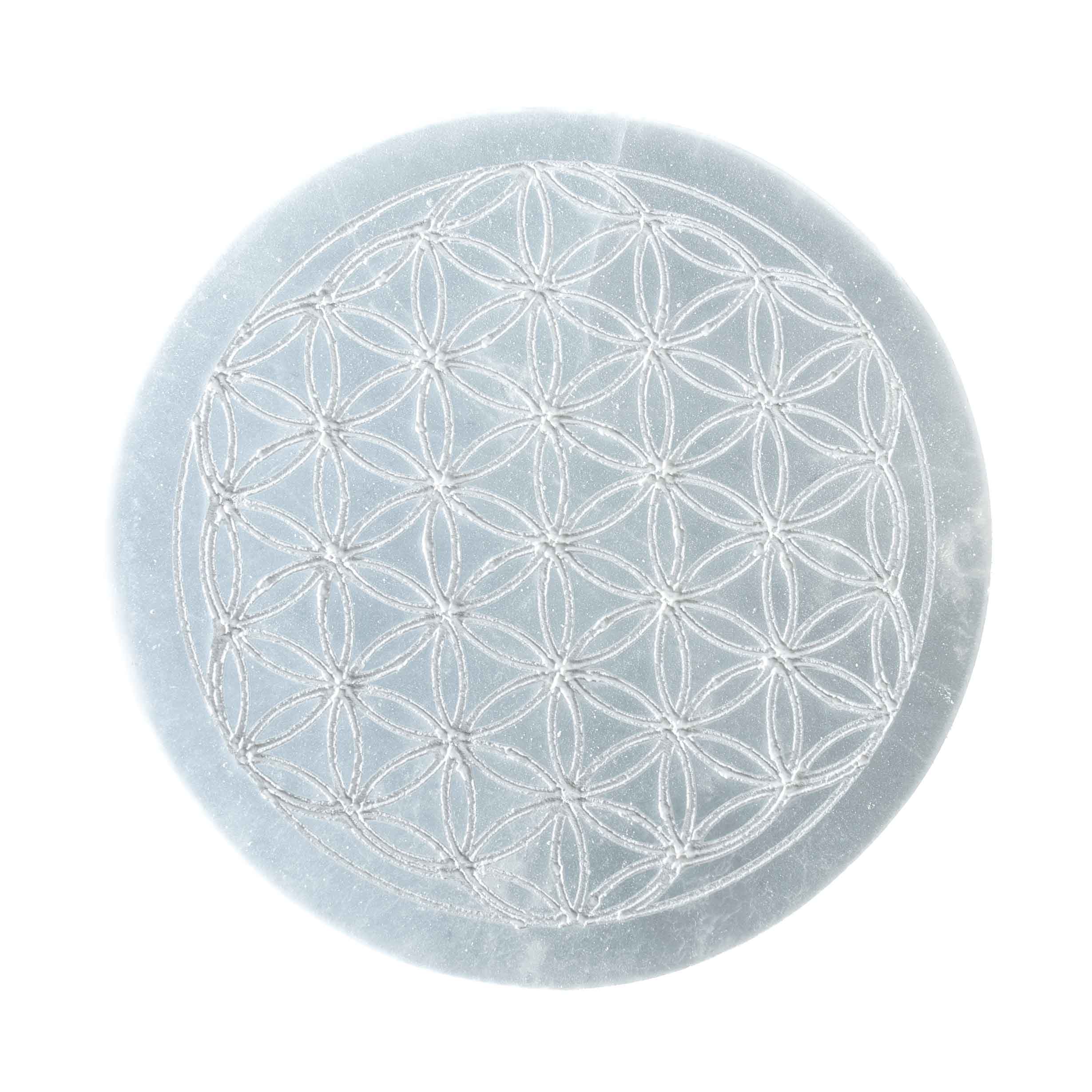 4-inch round white selenite crystal charging plate engraved with Flower of Life sacred geometry pattern on white background.