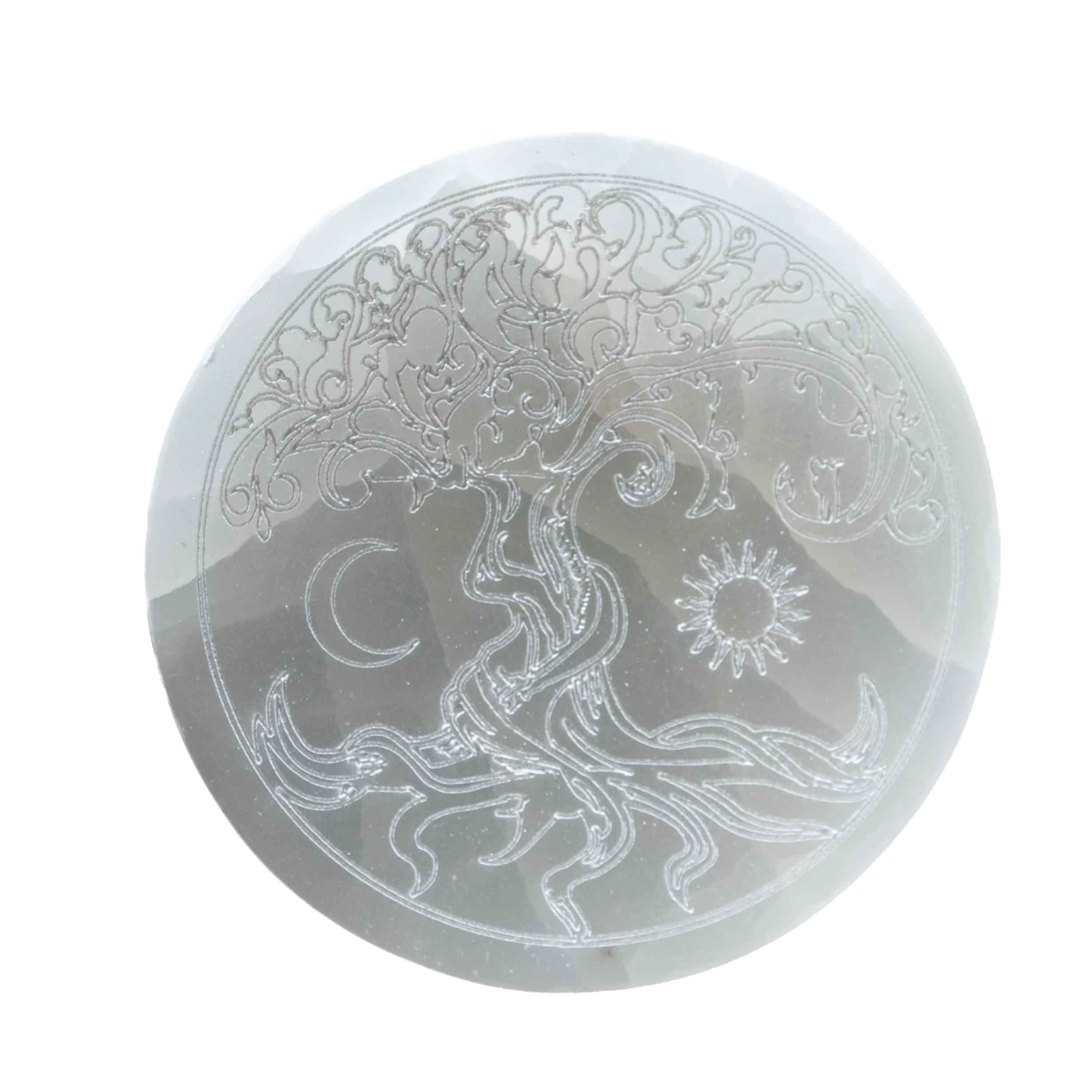 5.5-inch round white selenite crystal charging plate engraved with Tree of Life, crescent moon, and sun design on white background.